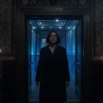 A WOMAN WALKING IN A ROOM AND BEING MONITORED BY SPIRITS