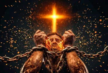 A pair of rough, chained hands burst free from heavy metal chains as fiery orange sparks fly upward, while a glowing golden cross of light shines powerfully in the dark background, symbolizing Jesus breaking spiritual bondage.